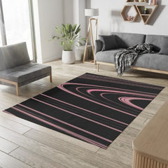 Tapis Dobby noir avec anneaux roses en forme de Saturne