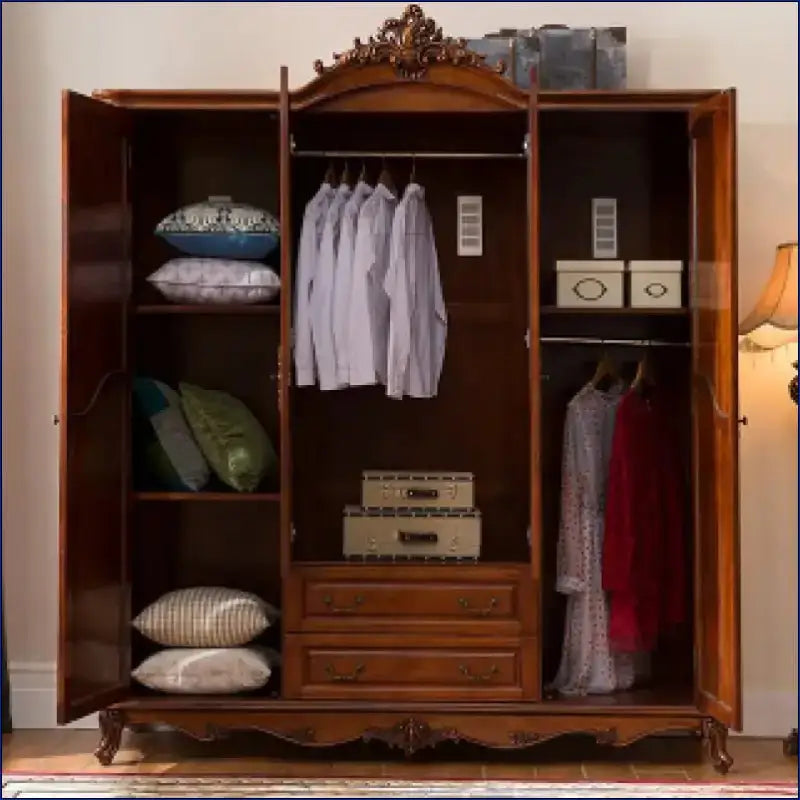 Ornate wooden wardrobe with three compartments and decorative carved crown molding.