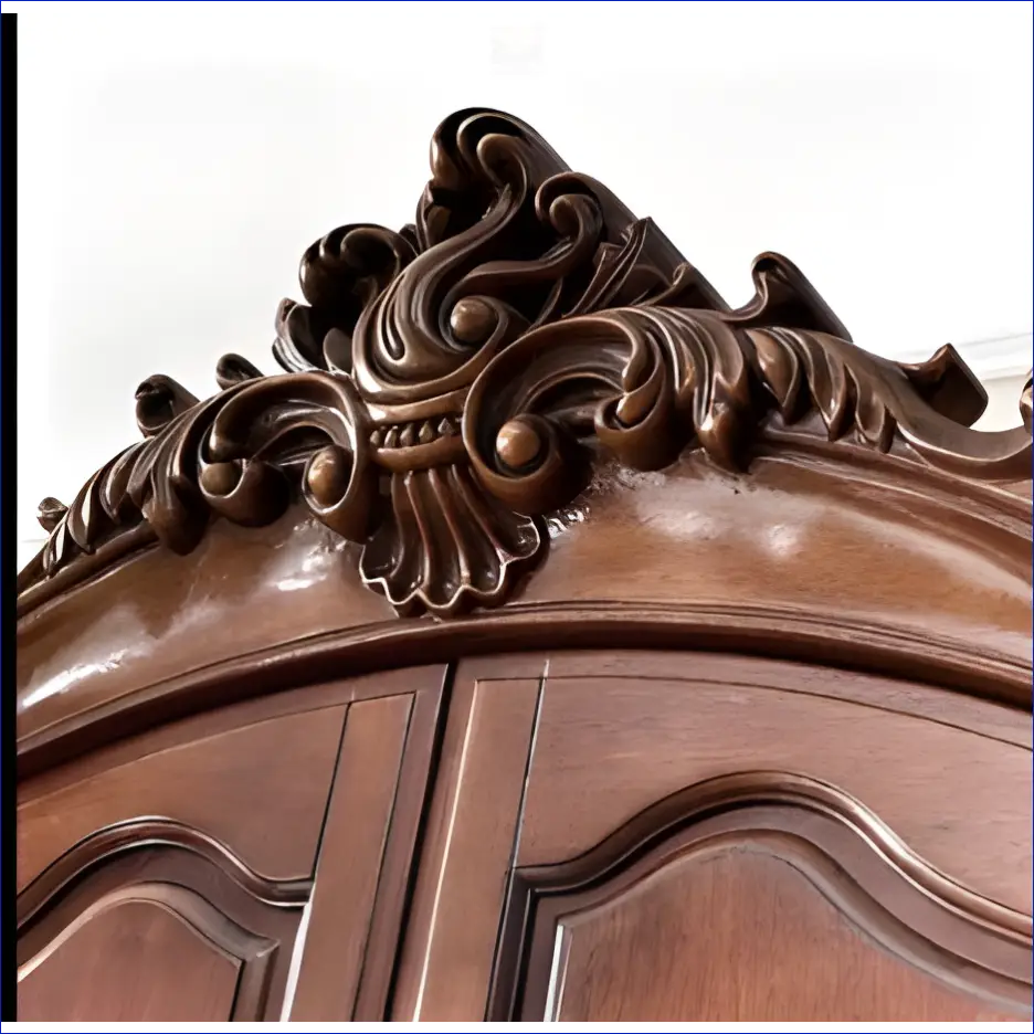 Ornately carved wooden furniture detail with scrollwork and floral motifs in dark brown.