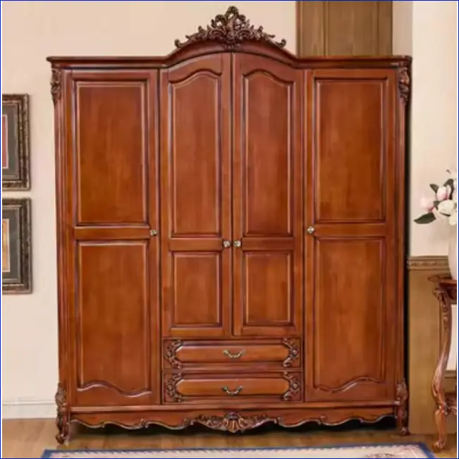 Ornate wooden armoire with carved details, double doors, and two drawers.