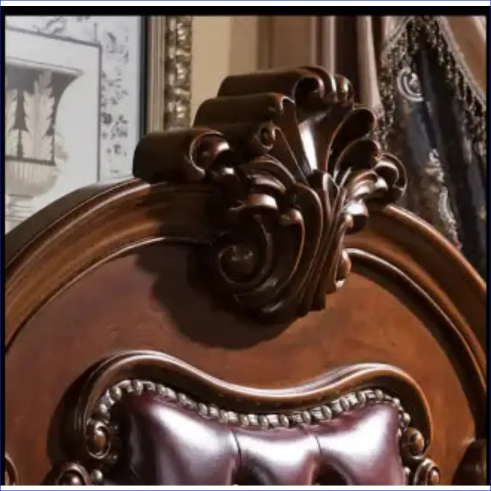 Ornate wooden headboard with intricate carvings and leather upholstery.