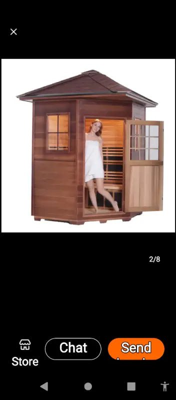 Wooden outdoor sauna cabin with glass door and illuminated interior.