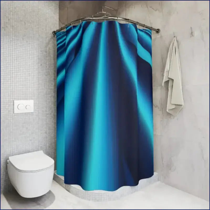 Turquoise and navy blue gradient shower curtain hanging from a rod.