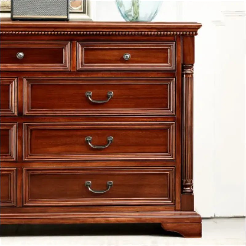 Traditional wooden dresser with multiple drawers and brass hardware.